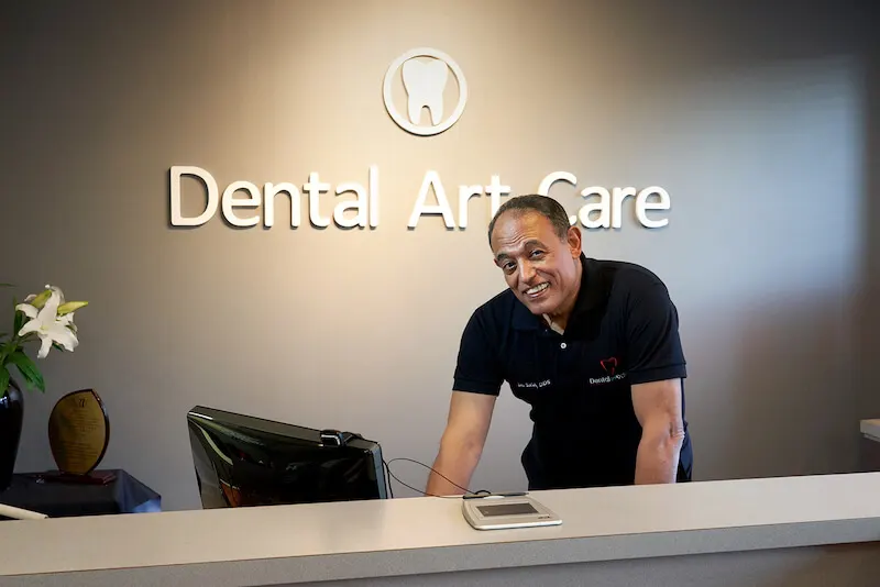 Dr. Saleh Elahwal at the front desk of Dental Art Care