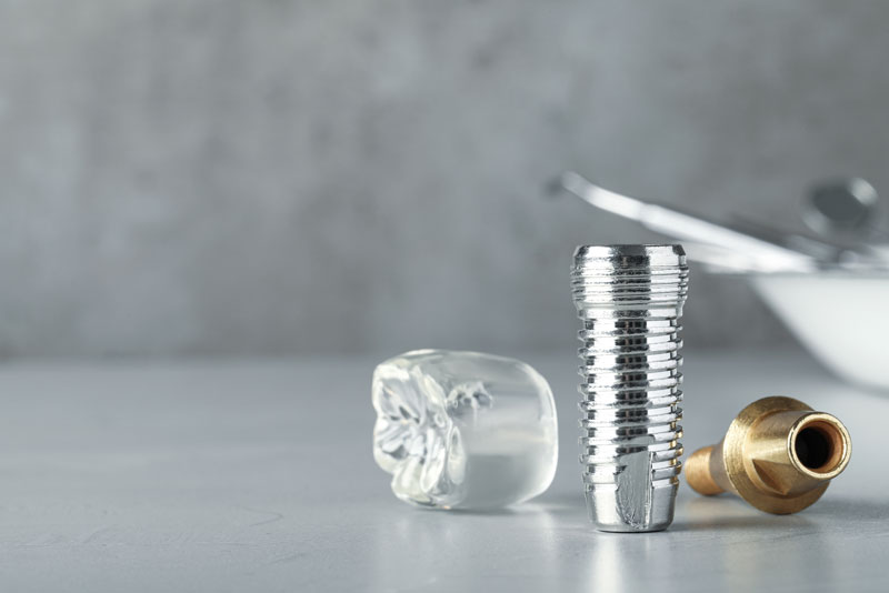 a titanium dental implant post and crown model.